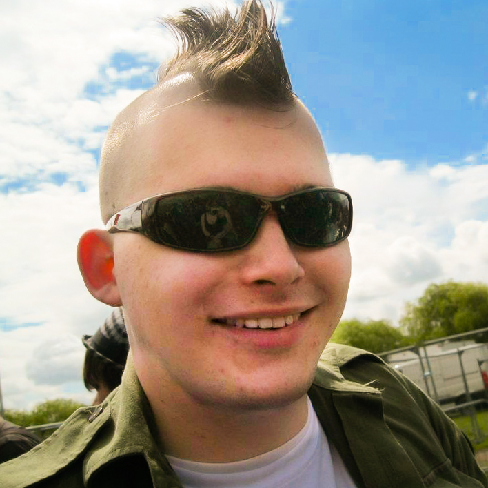 Rob with a mohawk and sunglasses, smiling