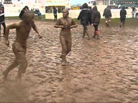 Two muddy people playing in mud