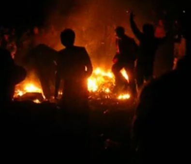 Fire and rioters at night at Reading festival
