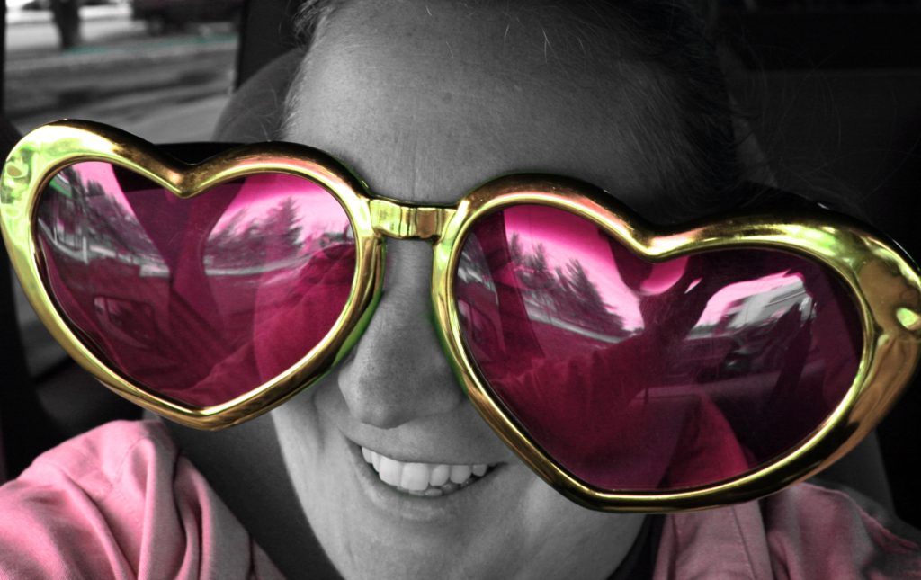 woman wearing oversides rose coloured glasses