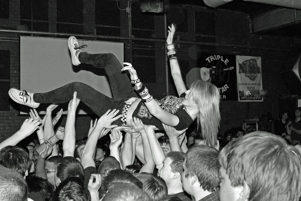 black and white photo showing someone crowd surfing