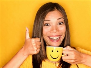 lady with a huge fake smile holding a smiley face mug