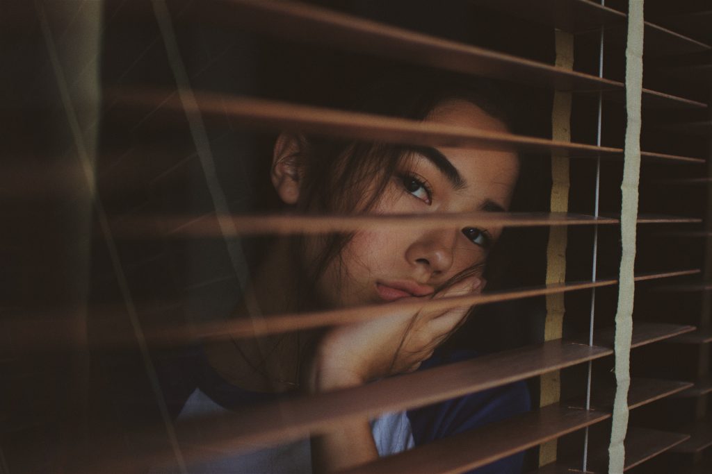 Sad person looking out of their window. By Joshua Rawson-Harri from Unsplash