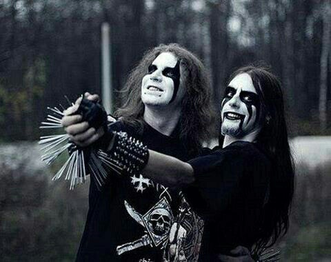black and white photo of two black metal fans in corpse makeup smiling and being silly