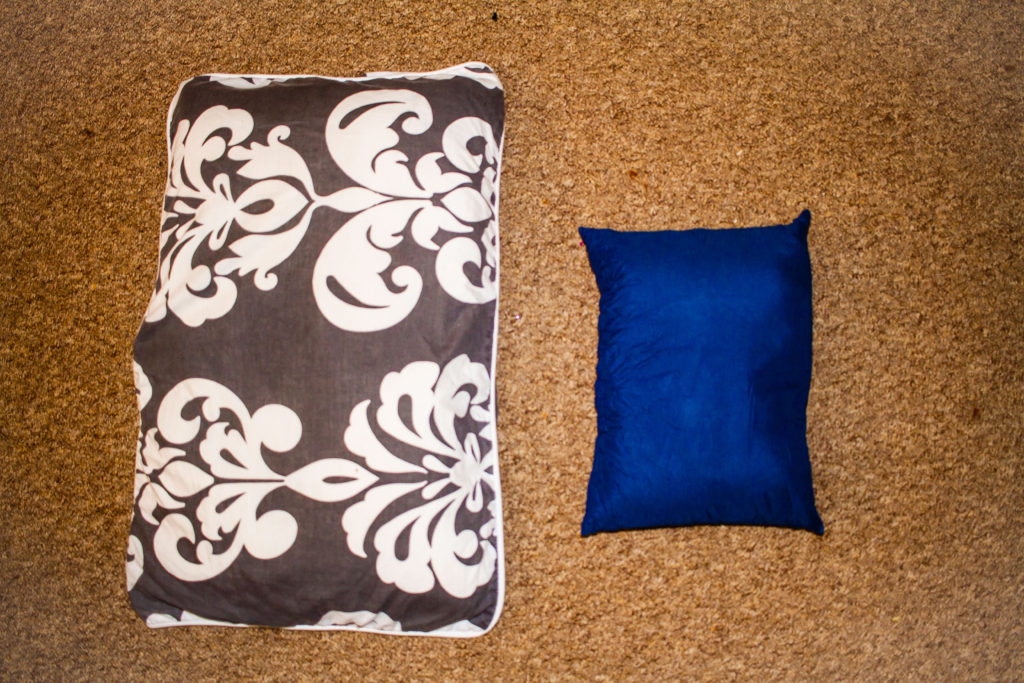 Size comparison of a regular pillow to a camping pillow
